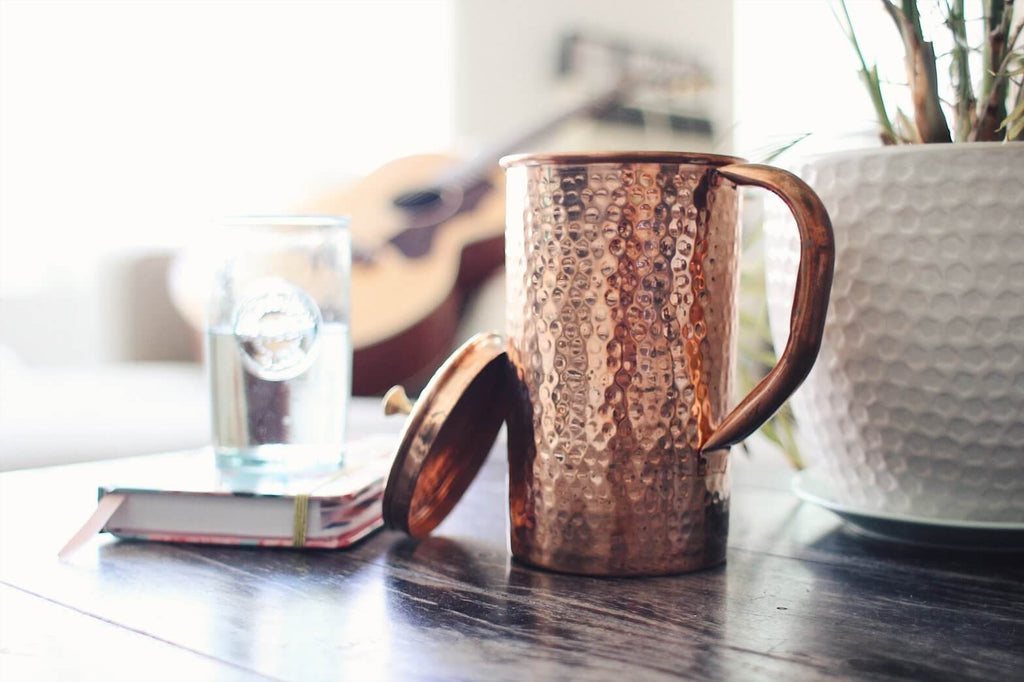 Shantiva copper pitcher placed on top of a wooden table