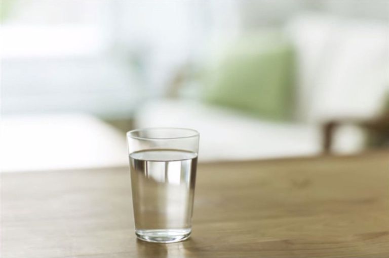 glass of water placed on top of a wooden table